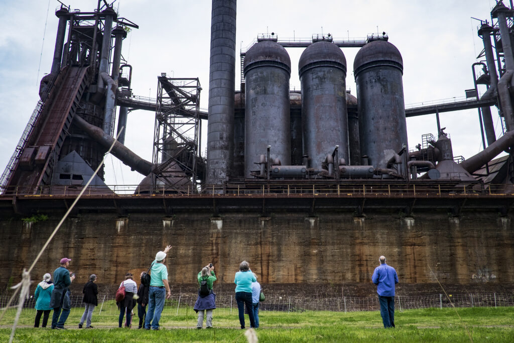 A retired steel worker gives a tour at his former work site at the Carrie Furnaces in Rankin, Pennsylvania. (By Pete Marovich)